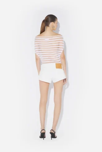 Los pantalones cortos de denim blanco con botones